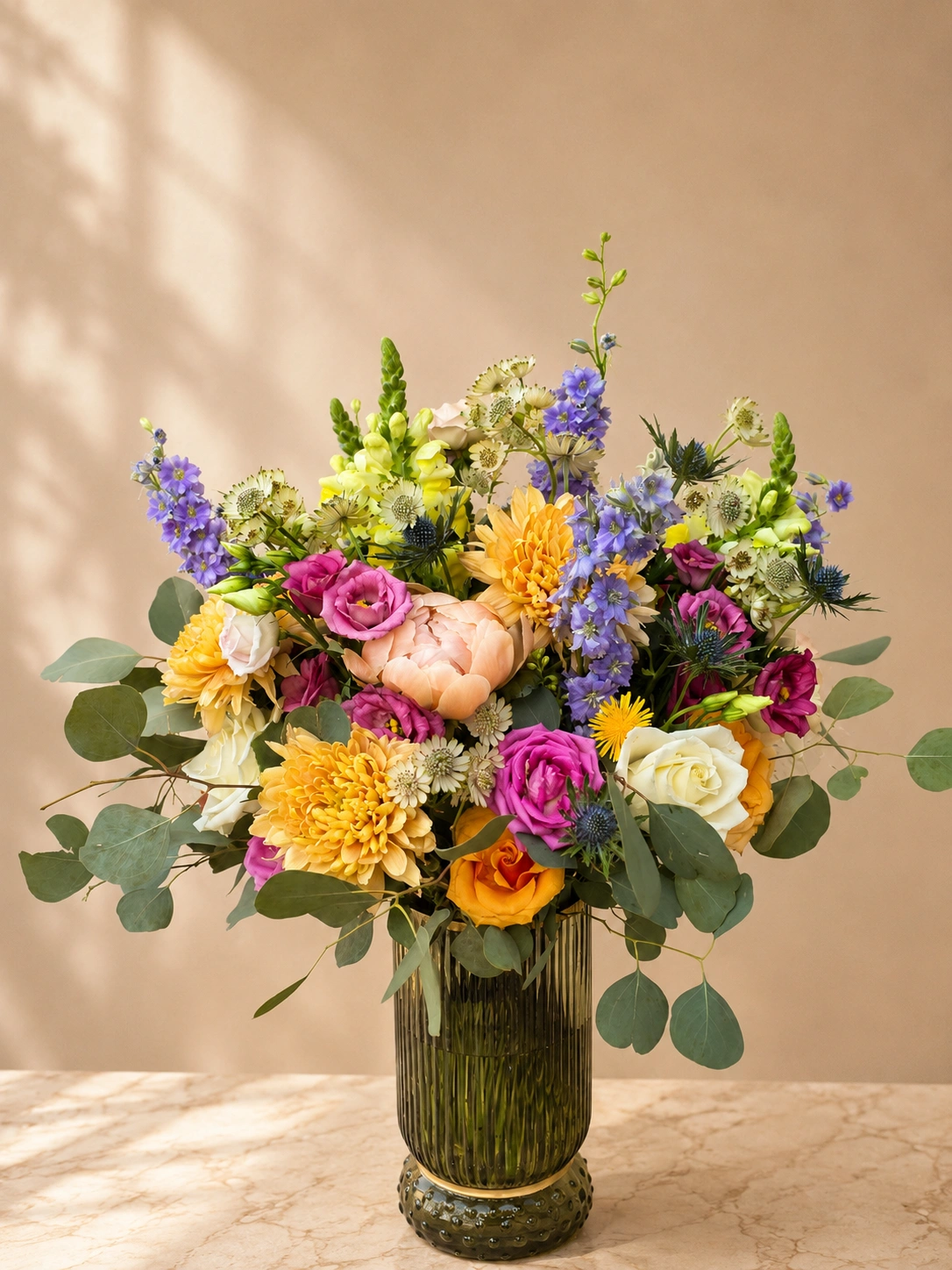 Luxury seasonal vase arrangement with peach, yellow, pink, blue and white flowers for Bloomsmith weekly and fortnightly floral subscriptions